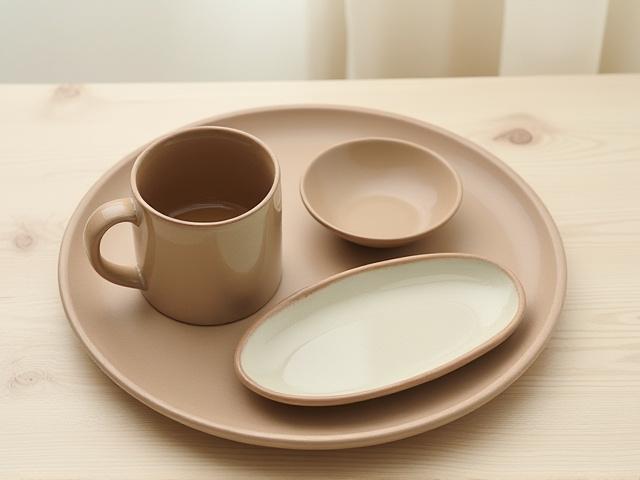 Assortment of hand-crafted functional pottery including mugs and bowls